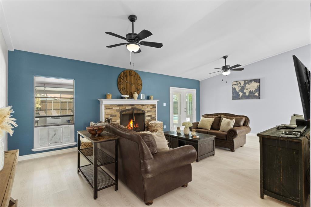 2113 Victoria Road Carrollton, TX 75007 - Photo 4 of 19 a living room with furniture a fireplace and a window