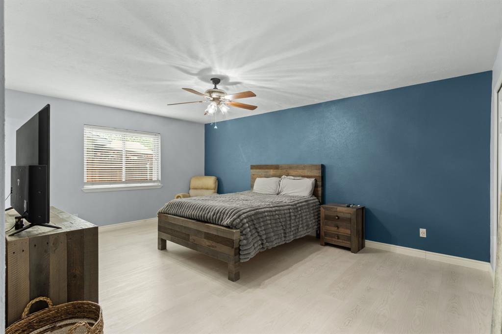 2113 Victoria Road Carrollton, TX 75007 - Photo 10 of 19 a living room with furniture a flat screen tv and a window