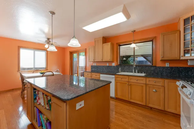 a kitchen with center island table and chairs