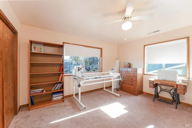 a living room with furniture a rug and a window