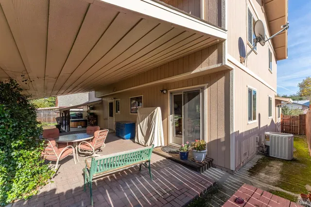 a view of a chairs and table in the balcony