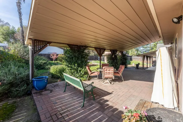 a view of a patio with table and chairs potted plants with wooden floor