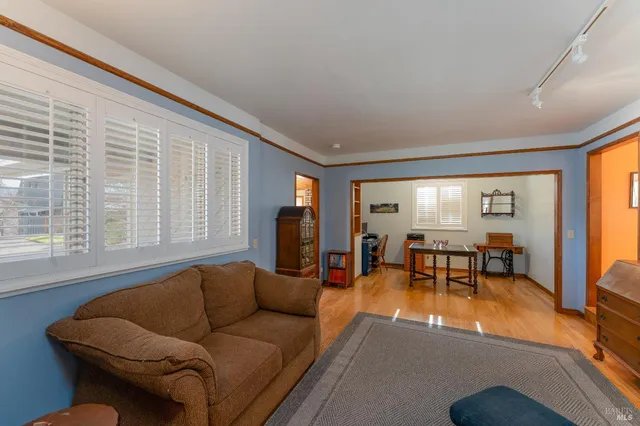 a living room with furniture and large windows