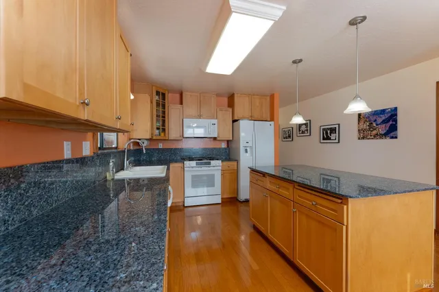 a kitchen with stainless steel appliances granite countertop a sink and cabinets