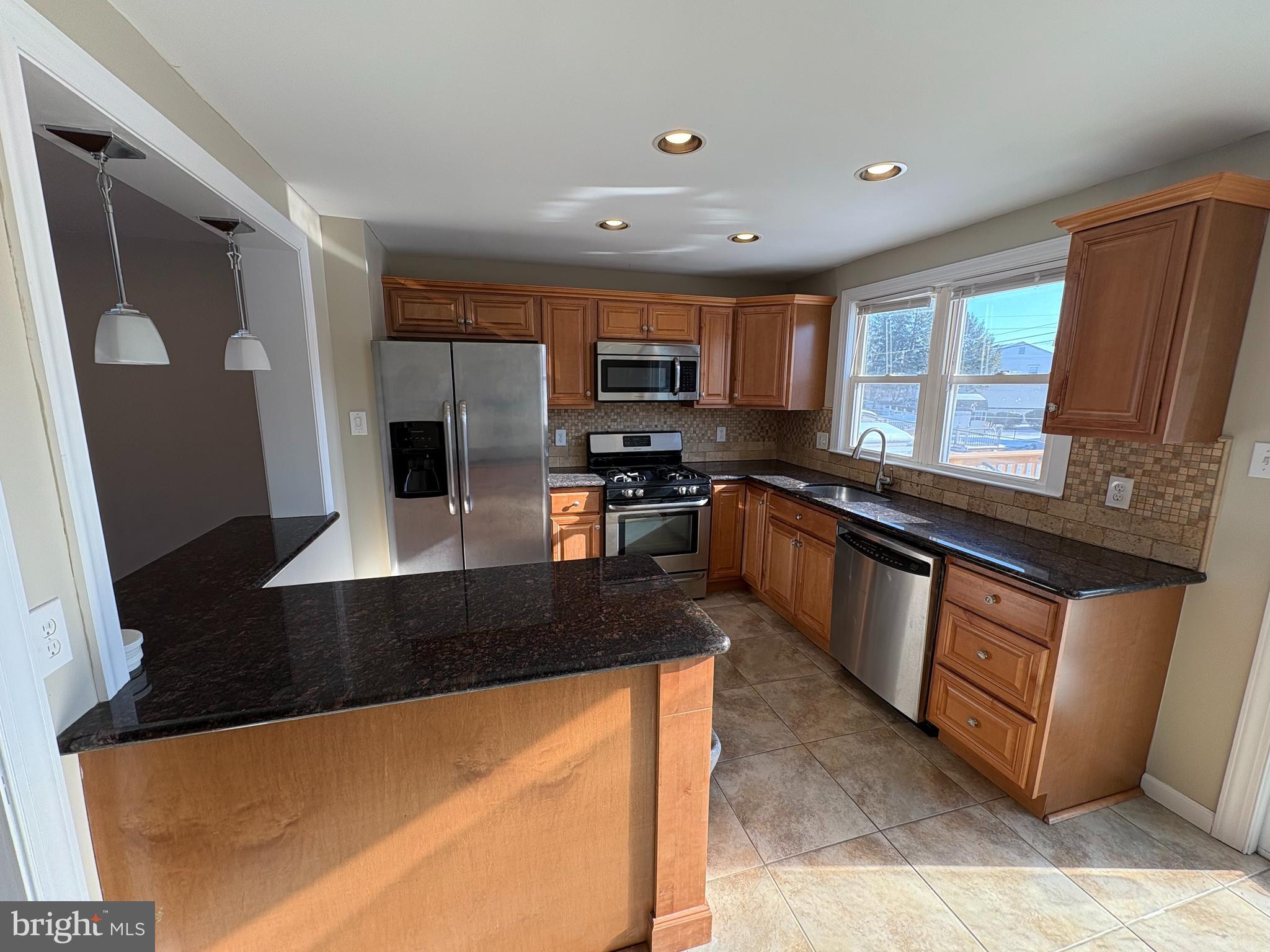 3251 Morning Glory Road Philadelphia, PA 19154 - Photo 6 of 19 a kitchen with stainless steel appliances granite countertop a stove a sink and a microwave
