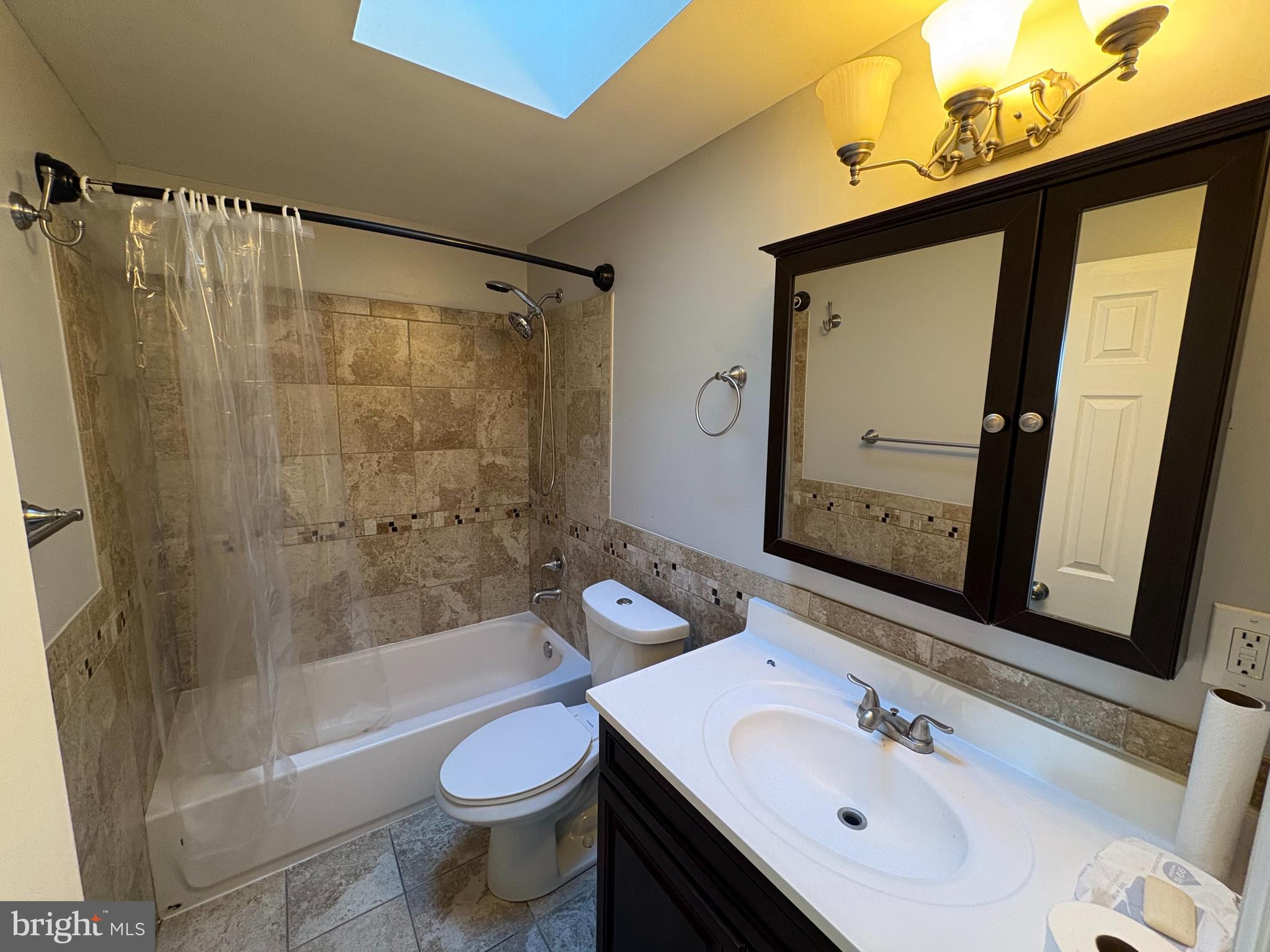 3251 Morning Glory Road Philadelphia, PA 19154 - Photo 9 of 19 a bathroom with a sink a toilet and shower a mirror