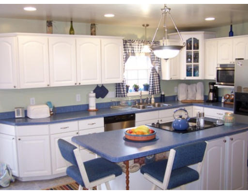 2001 Greenwich Road Hardwick, MA 01082 - Photo 6 of 27 a kitchen with a sink a stove and white cabinets