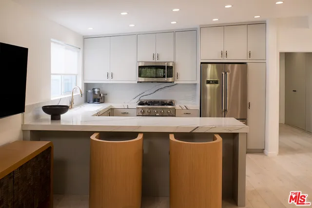 a kitchen with a sink stove and refrigerator