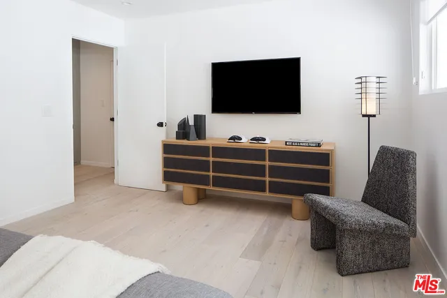 a view of a livingroom with furniture and a flat screen tv