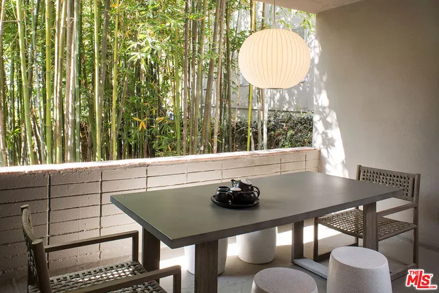 a view of a dining room with furniture and a window