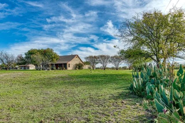 a view of a big yard with a house