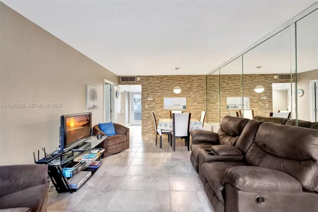 a living room with furniture gym equipment and a flat screen tv