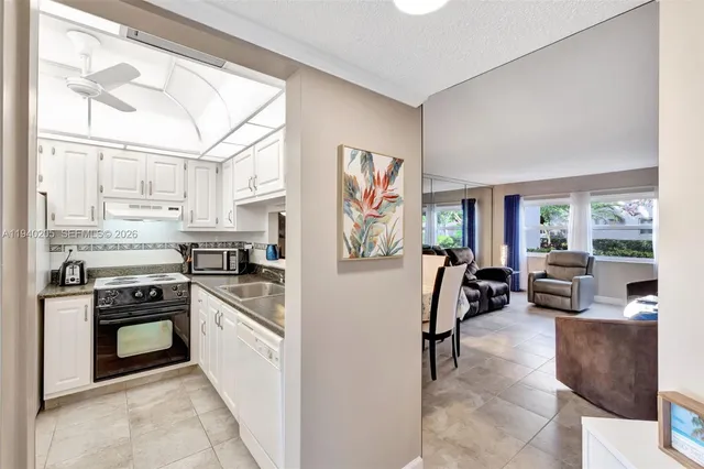 a kitchen with stainless steel appliances granite countertop a refrigerator and stove