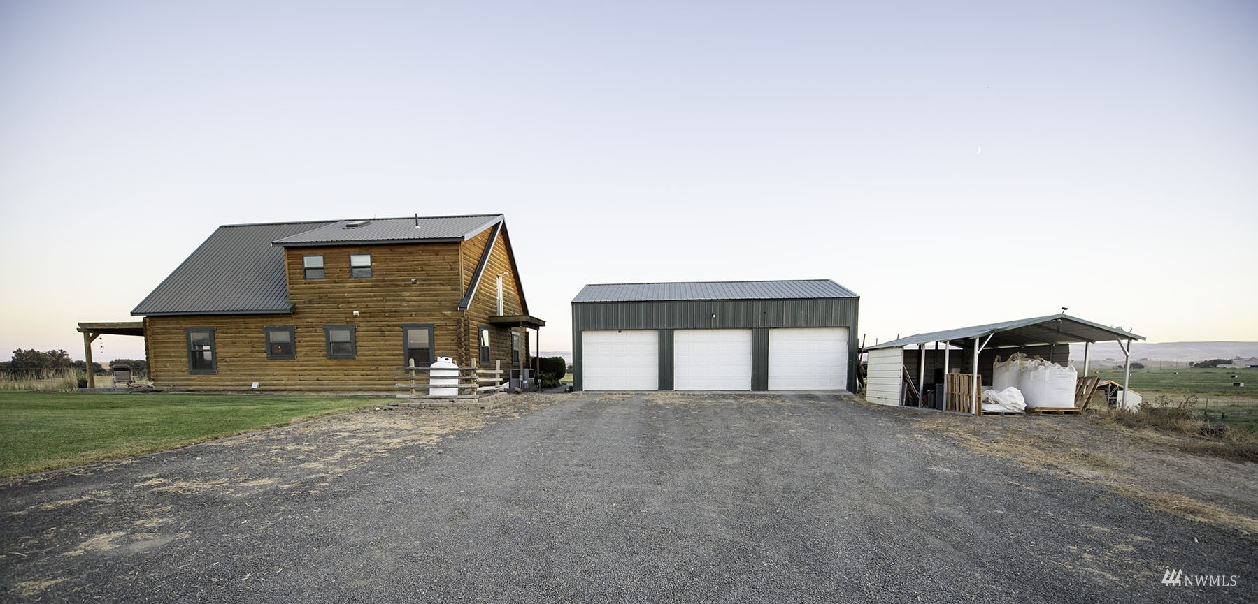 14352 Highway 12 Touchet, WA 99360 - Photo 7 of 40 a front view of a house with a yard and garage