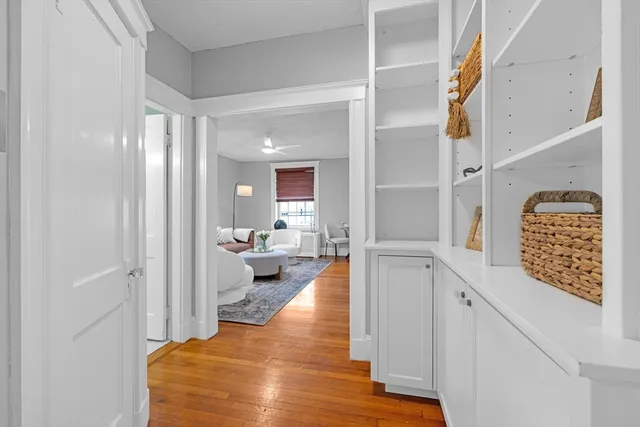 a living room with furniture potted plant and a large window