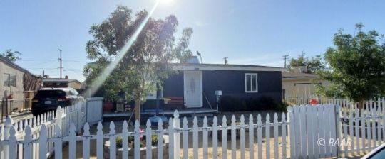 425 North Norma Street Ridgecrest, CA 93555 - Photo 28 of 33 a view of a house with a fence