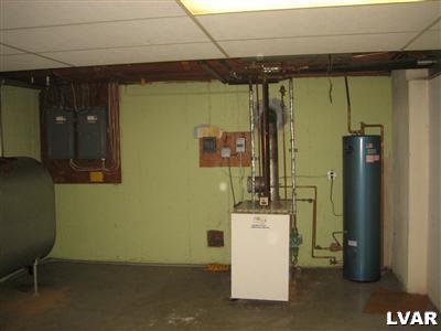 1129 Butztown Road Bethlehem, PA 18017 - Photo 30 of 32 Utility room in lower level includes furnace, oil fired h/w heater, oil tank, laundry tub and washer/dryer hook up. Finished ceiling tiles