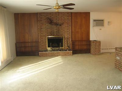 1129 Butztown Road Bethlehem, PA 18017 - Photo 3 of 32 Spacious living room with fireplace, built in a/c, shelving and planter boxes