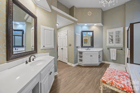 a bath room with a sink and a large mirror