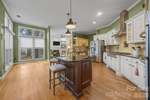 a large kitchen with stainless steel appliances lots of counter space and windows