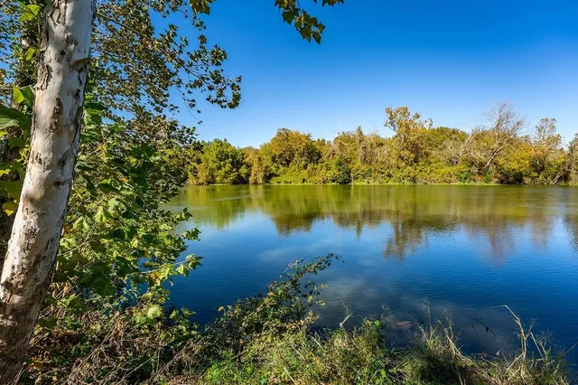 a view of a lake with houses in the back