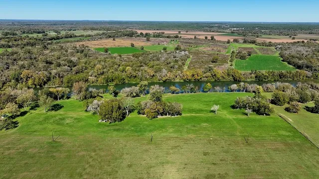 a view of a green field with an outdoor space