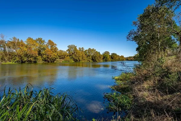 a view of a lake with houses in the back