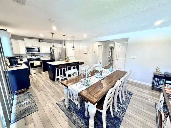 a living room with furniture a flat screen tv and a rug
