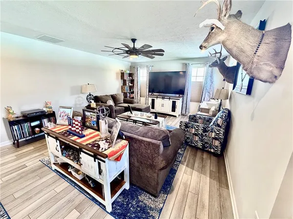 a dining room with furniture and wooden floor