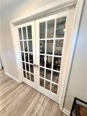 view of a livingroom with wooden floor and white doors
