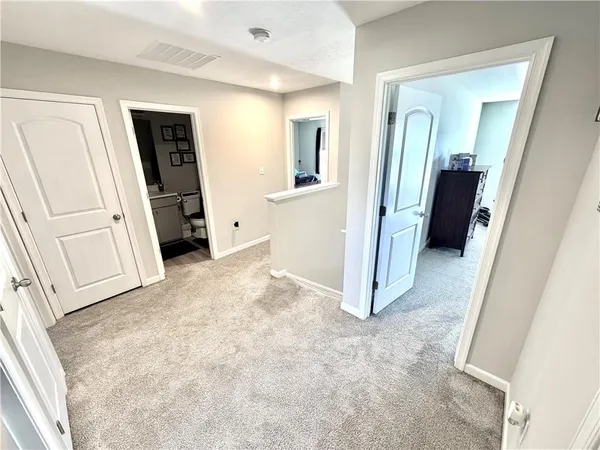 a bed room with a bed window and mirror