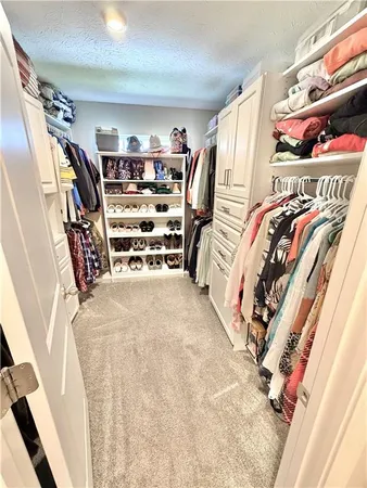 a utility room with dryer washer and a view of living room