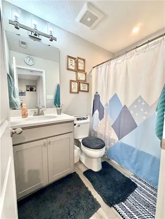 a living room with furniture a flat screen tv and a bed