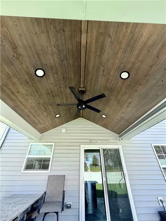 a front view of a house with a big yard and large trees