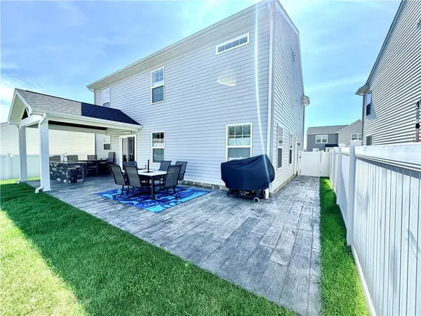 a view of a patio with a table chairs and a backyard