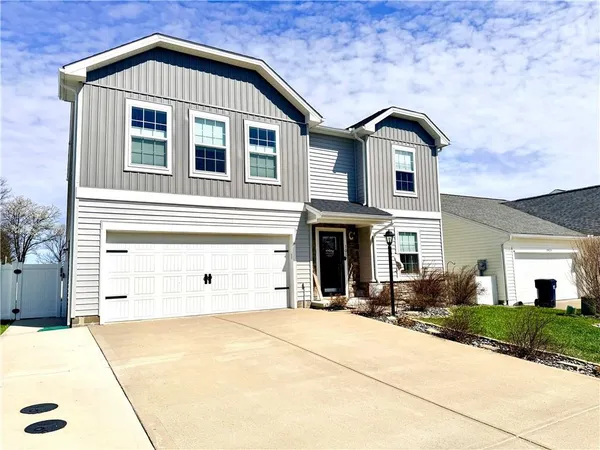 a view of a big house with a yard