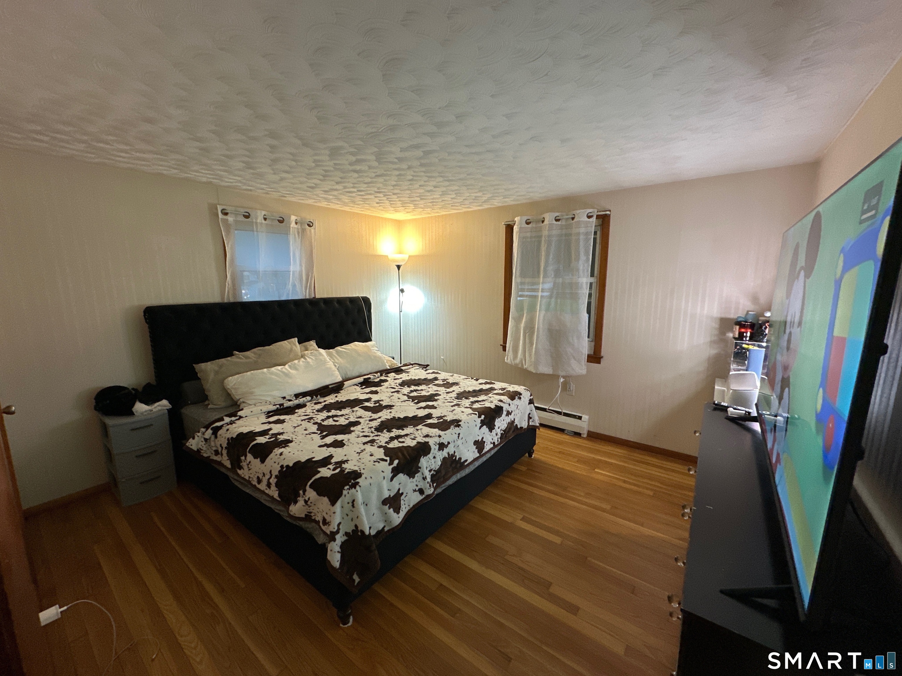 35 Brook Road Enfield, CT 06082 - Photo 10 of 25 a bedroom with a bed and flat screen tv
