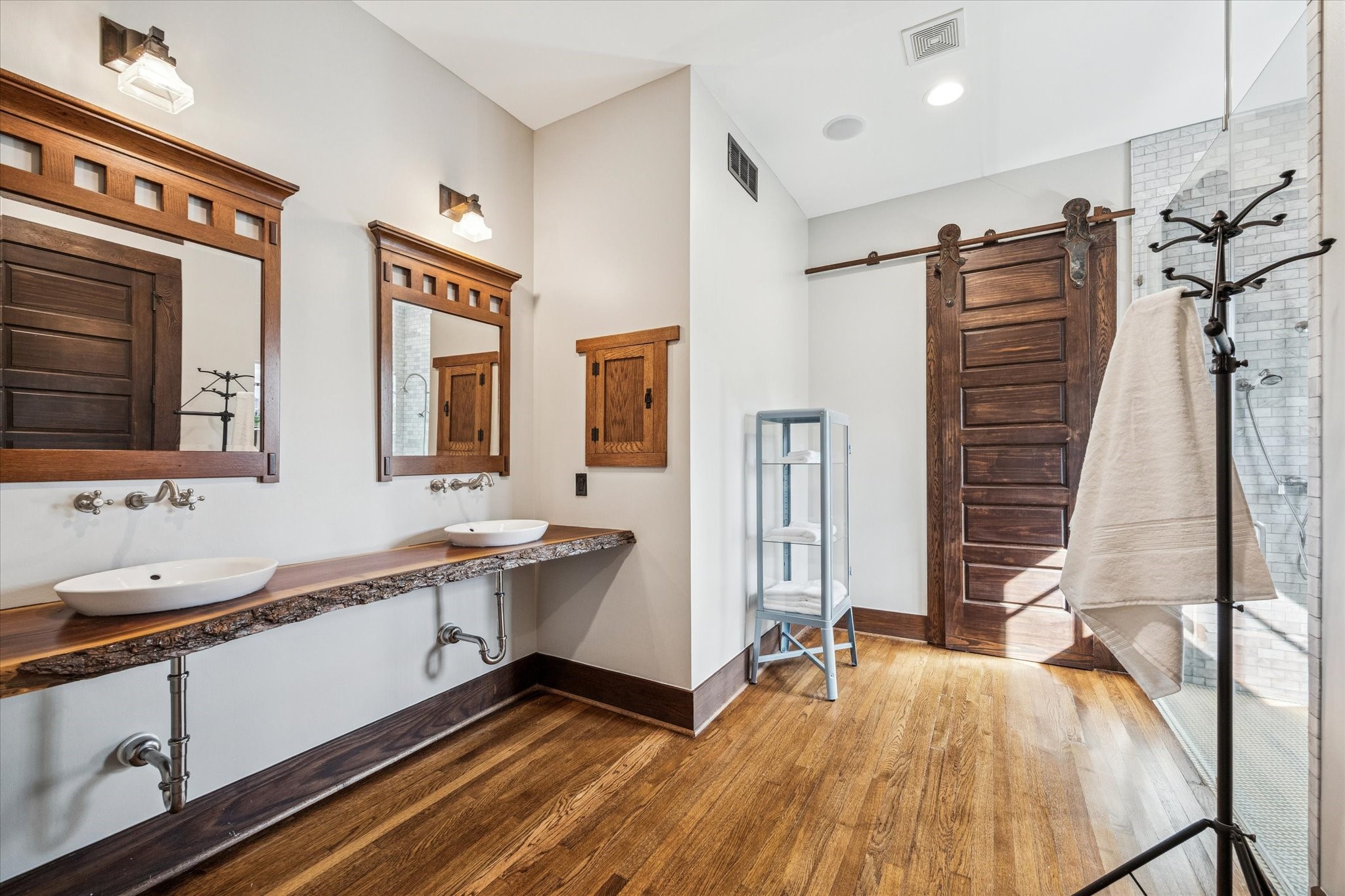 512 Archer Street Houston, TX 77009 - Photo 24 of 40 Stunning live edge hard wood countertop with double sinks. The sliding door on casters leads to the impressive walk-in closet with built-ins.