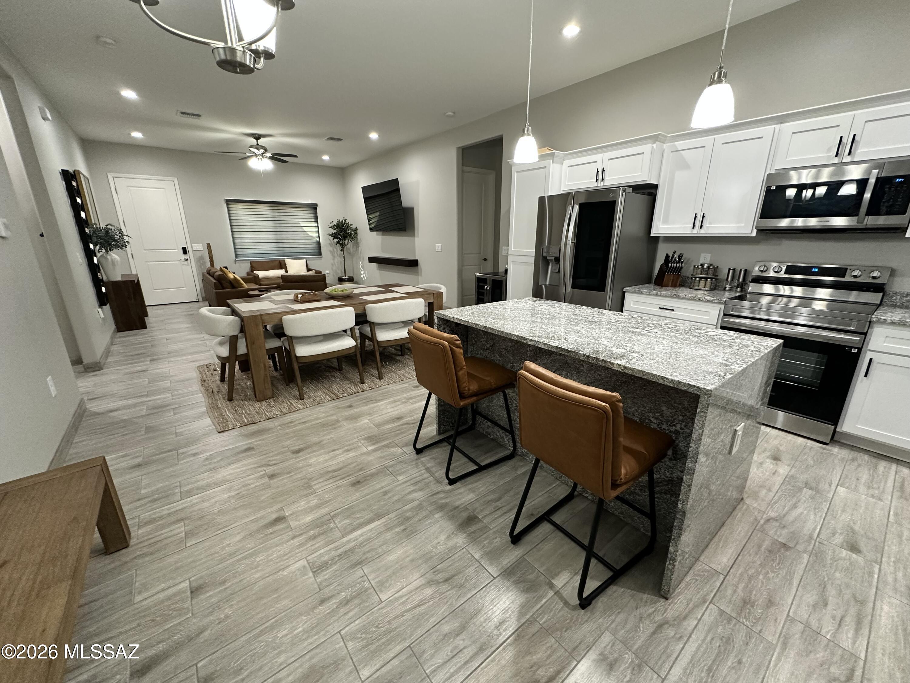 117 Ver Patria Rio Rico, AZ 85648 - Photo 3 of 28 a large kitchen with a table and chairs in it
