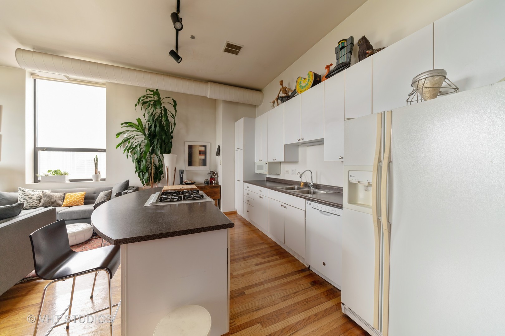 910 South Michigan Avenue, Unit 601 Chicago, IL 60605 - Photo 3 of 11 a kitchen with kitchen island a counter space a sink a window and appliances