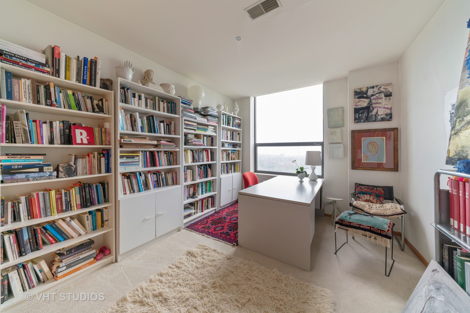 910 South Michigan Avenue, Unit 601 Chicago, IL 60605 - Photo 5 of 11 a living room with a book shelf and a book shelf