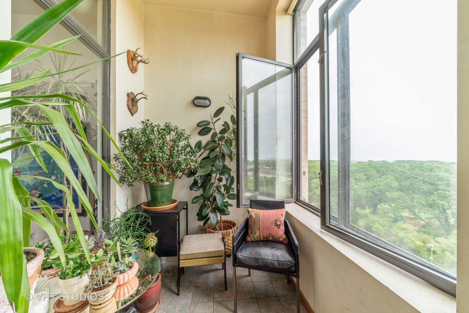 910 South Michigan Avenue, Unit 601 Chicago, IL 60605 - Photo 6 of 11 a living room filled with furniture and a potted plant