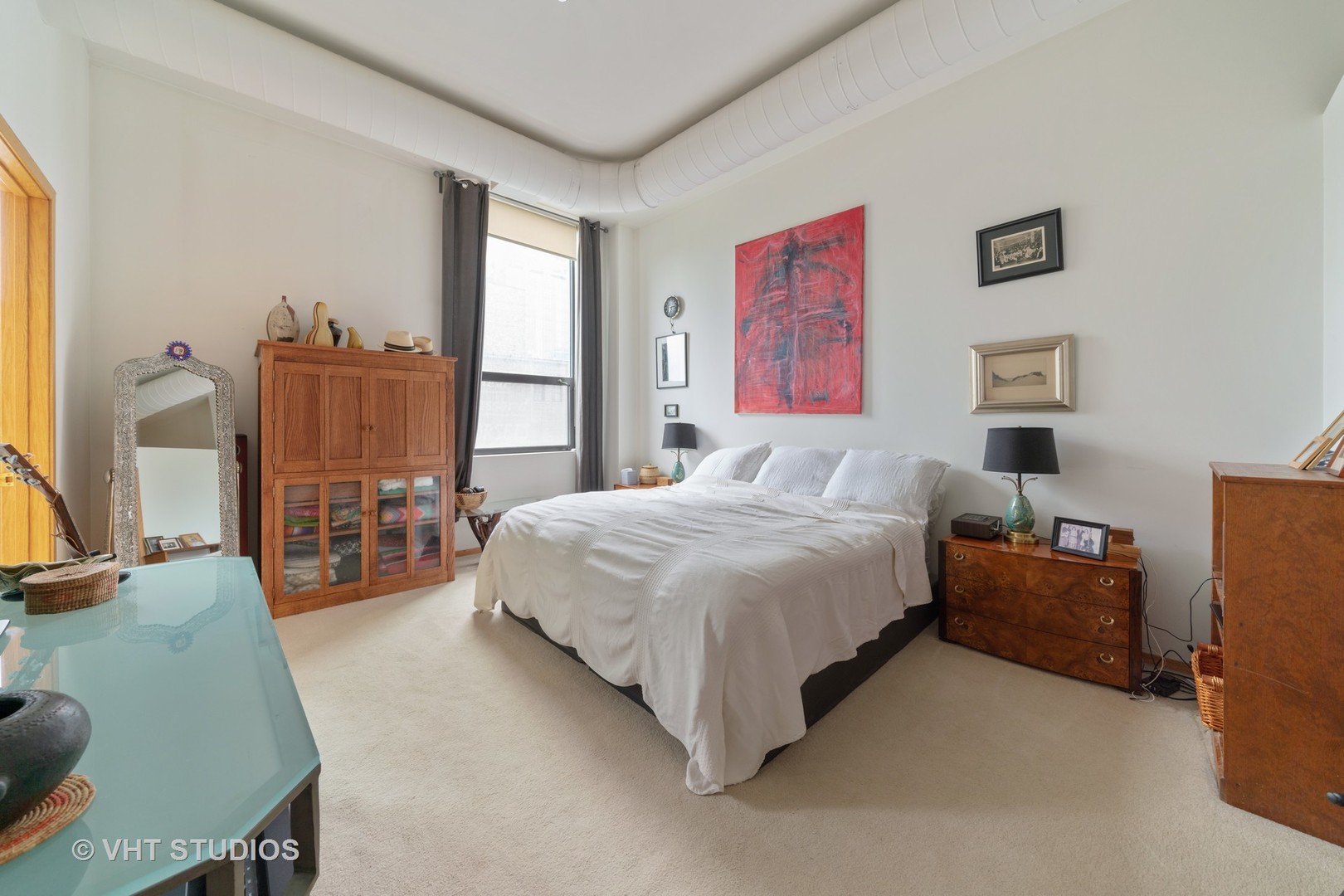 910 South Michigan Avenue, Unit 601 Chicago, IL 60605 - Photo 7 of 11 a spacious bedroom with a bed and wooden floor