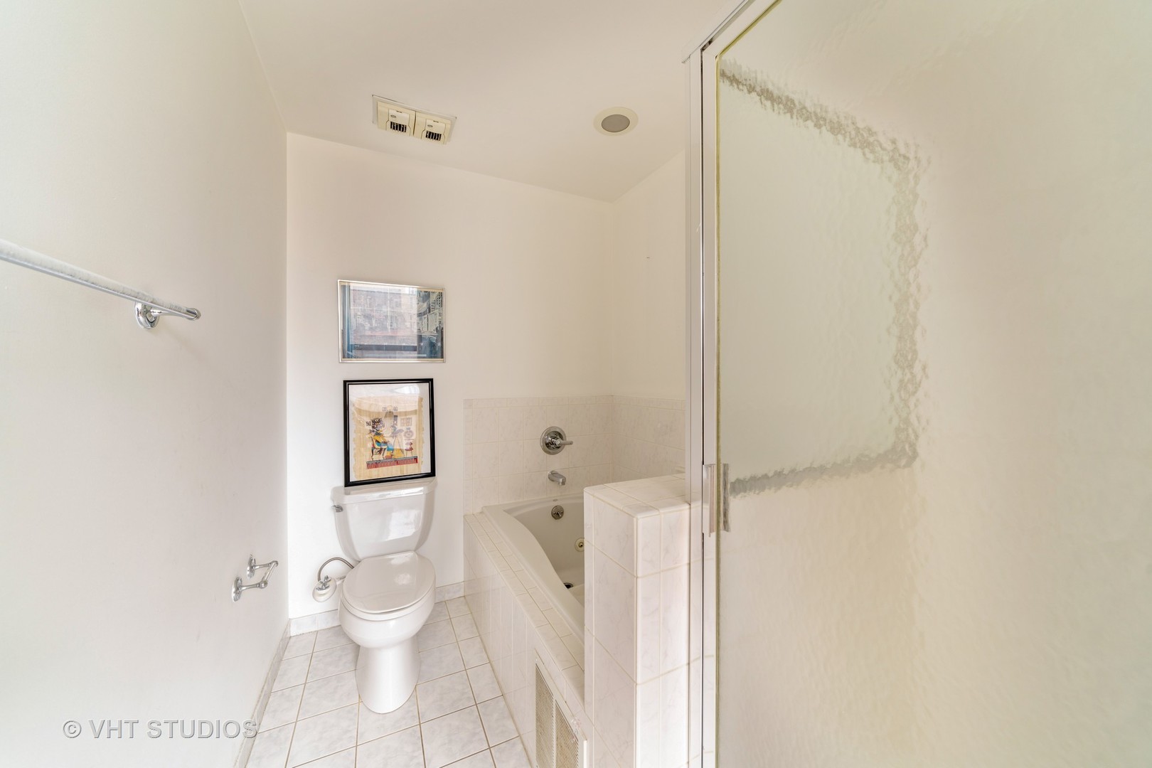 910 South Michigan Avenue, Unit 601 Chicago, IL 60605 - Photo 8 of 11 a white toilet sitting next to a bathroom sink