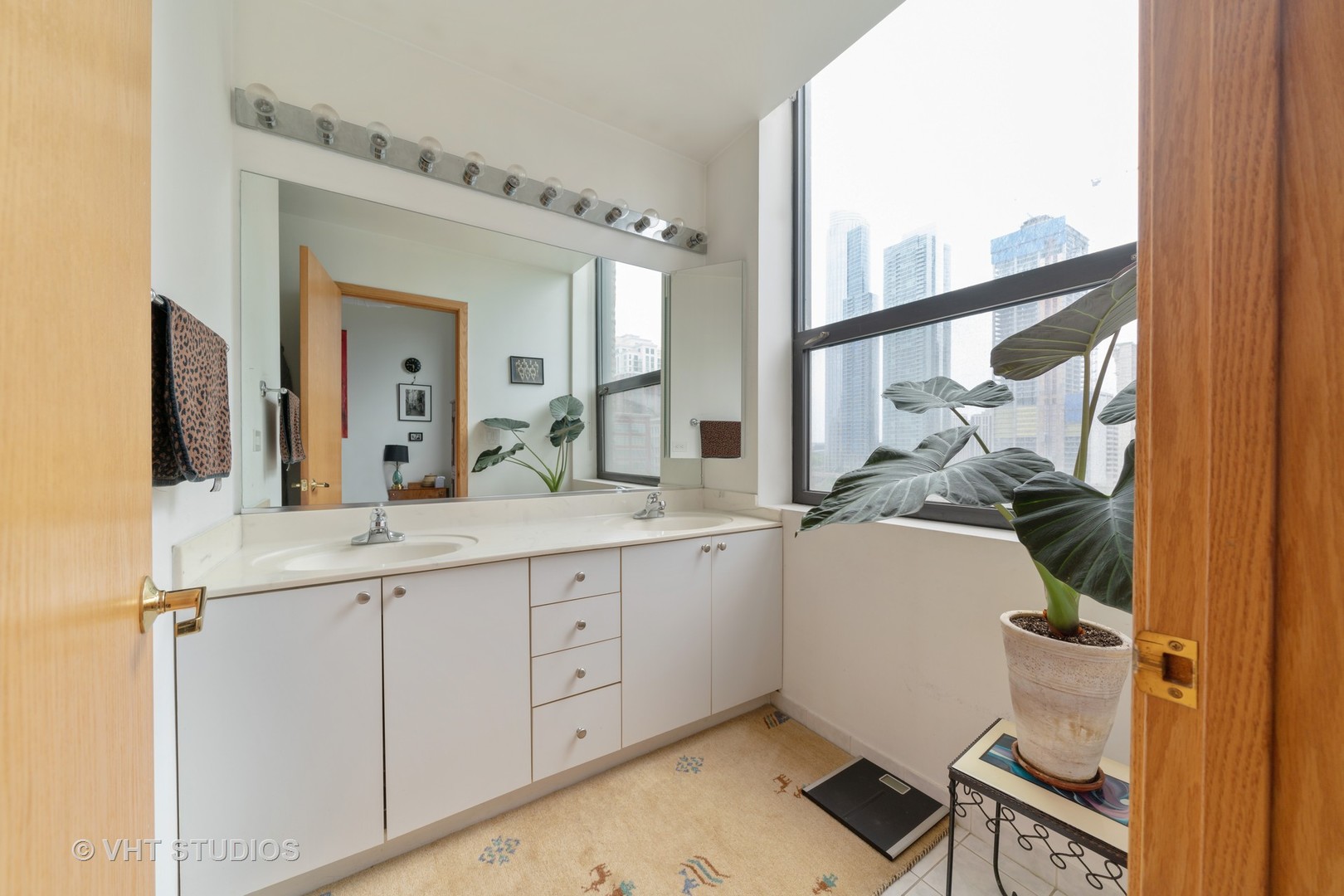910 South Michigan Avenue, Unit 601 Chicago, IL 60605 - Photo 9 of 11 a bathroom with a sink and a mirror