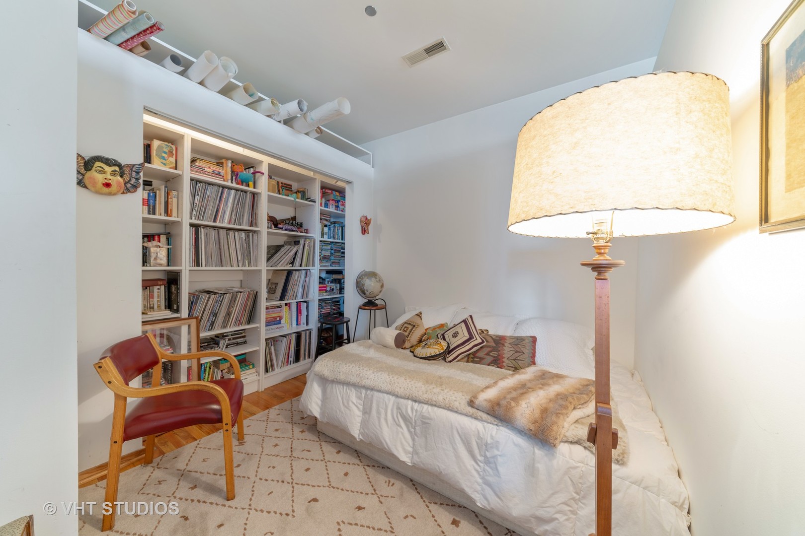 910 South Michigan Avenue, Unit 601 Chicago, IL 60605 - Photo 10 of 11 a bedroom with a bed and a chandelier