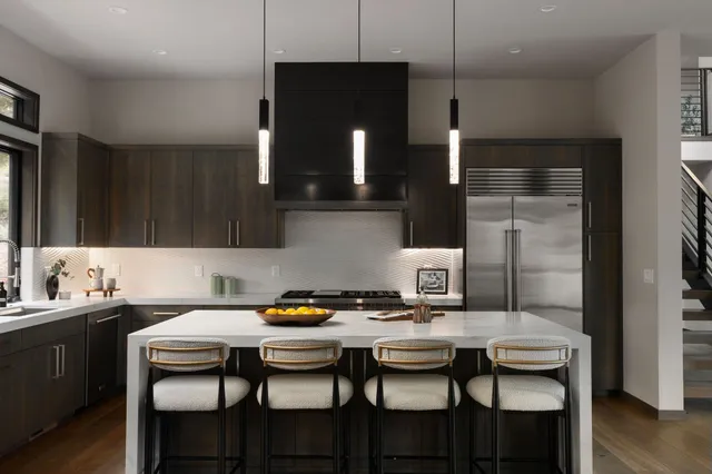 a kitchen with a table chairs and a view of kitchen