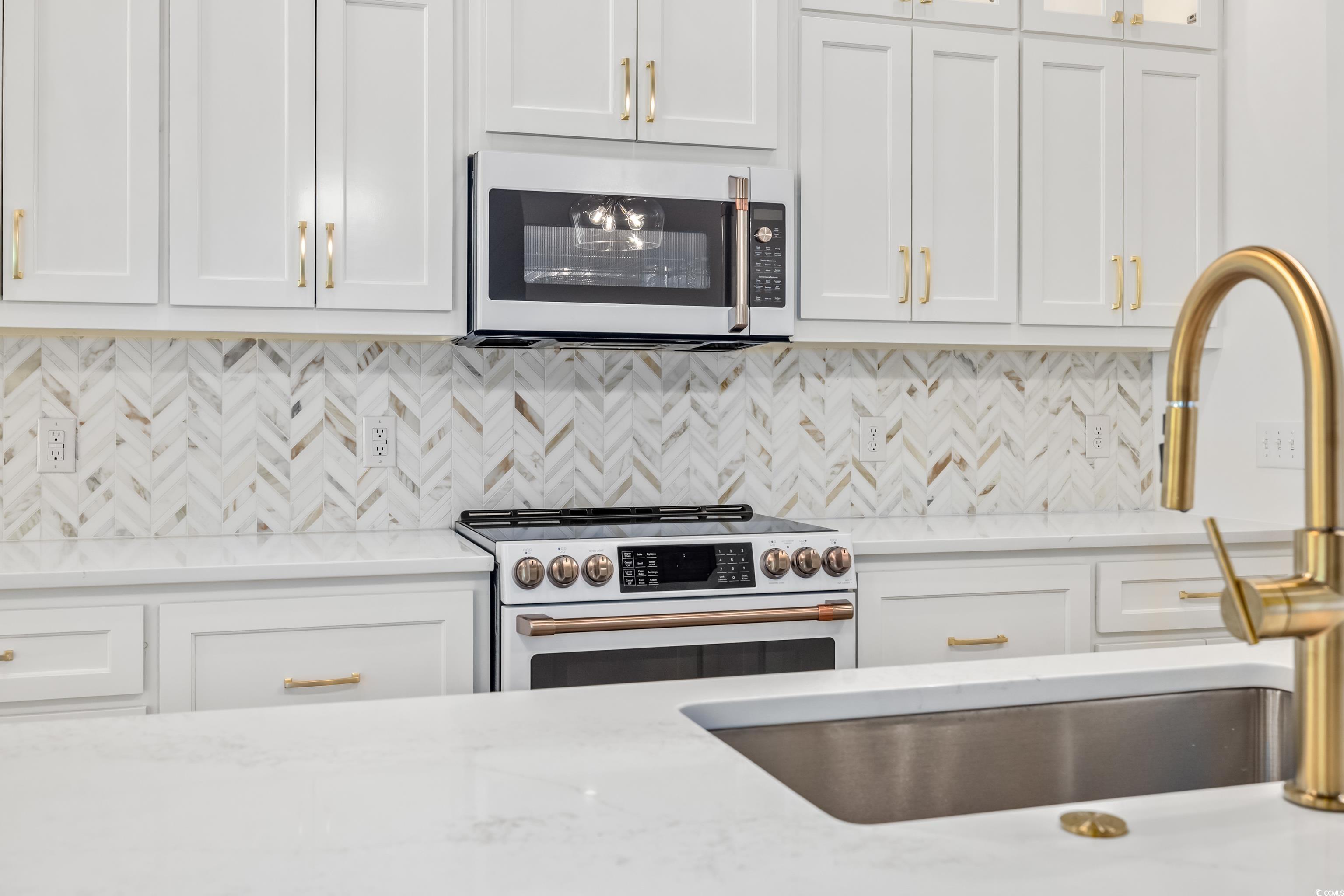 346 Ridge Road Galivants Ferry, SC 29544 - Photo 11 of 28 Kitchen with decorative backsplash, light stone counters, white cabinets, and white appliances