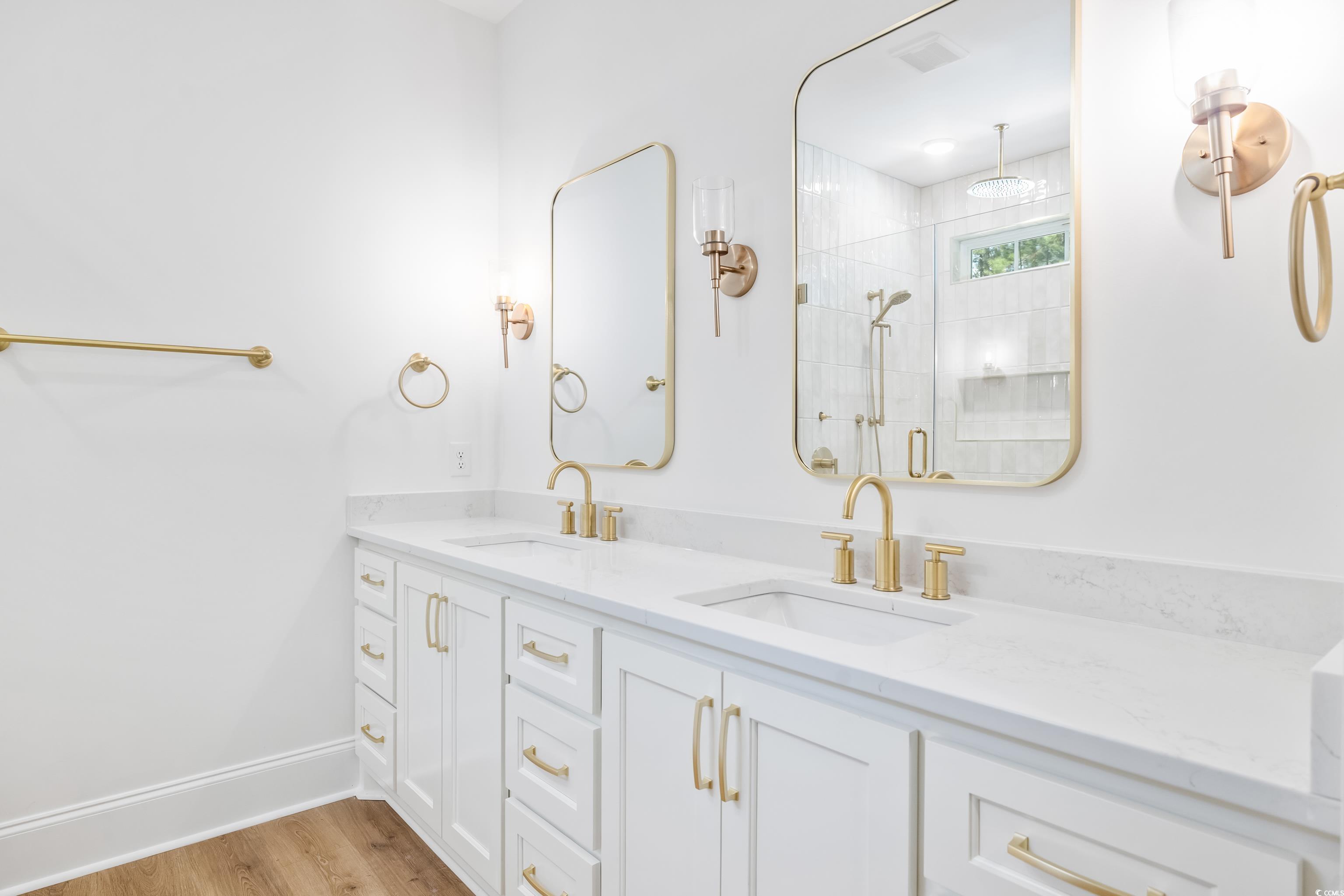 346 Ridge Road Galivants Ferry, SC 29544 - Photo 4 of 28 Full bath with light wood-type flooring, double vanity, and a stall shower