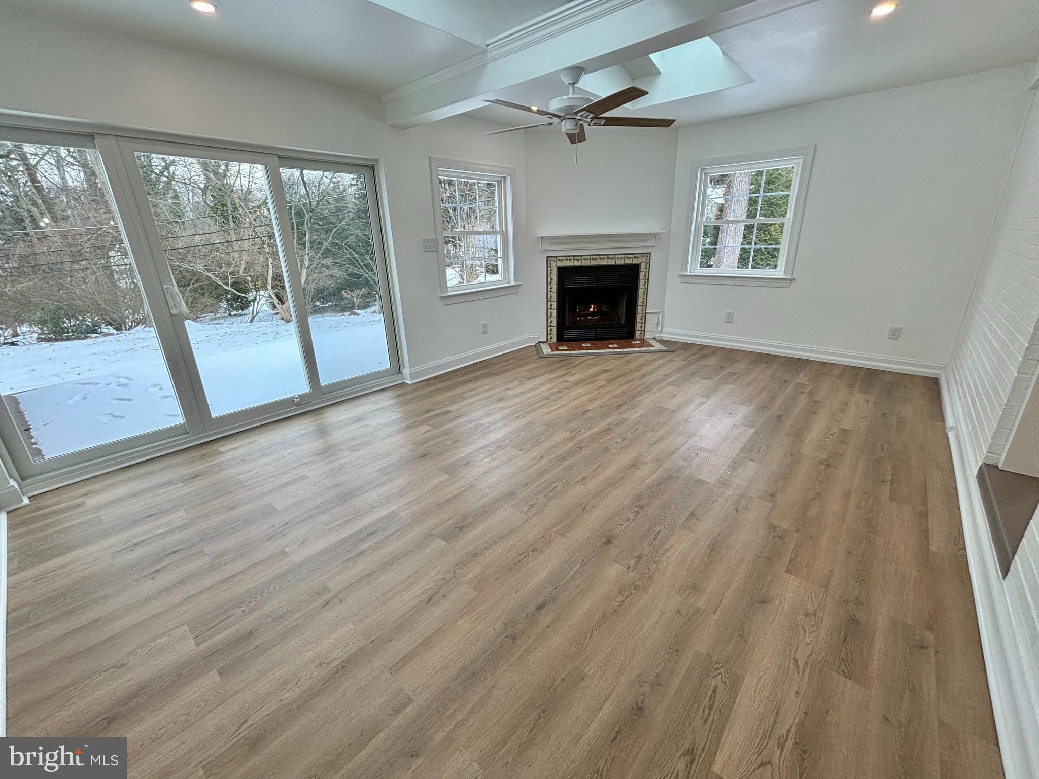 212 Grandview Road Media, PA 19063 - Photo 13 of 49 an empty room with wooden floor fireplace and windows